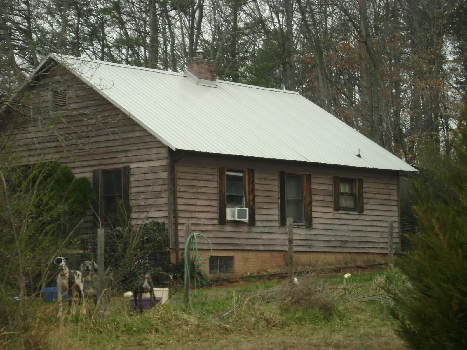 White metal roof on an old wood sided farmhouse, from a Metal Roof Installation job in Hollywood